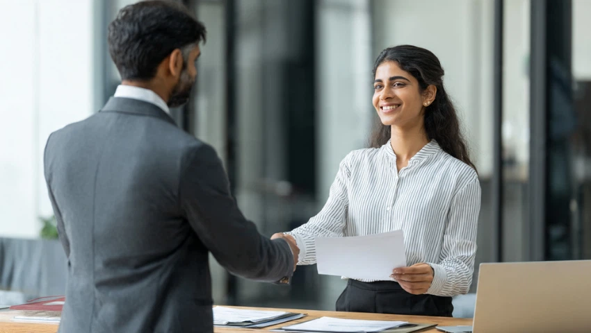 Student handing documents to attestation expert